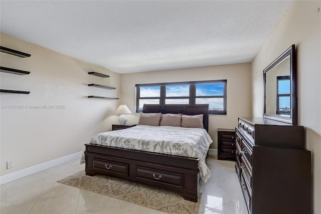 bedroom featuring light tile patterned flooring and a textured ceiling