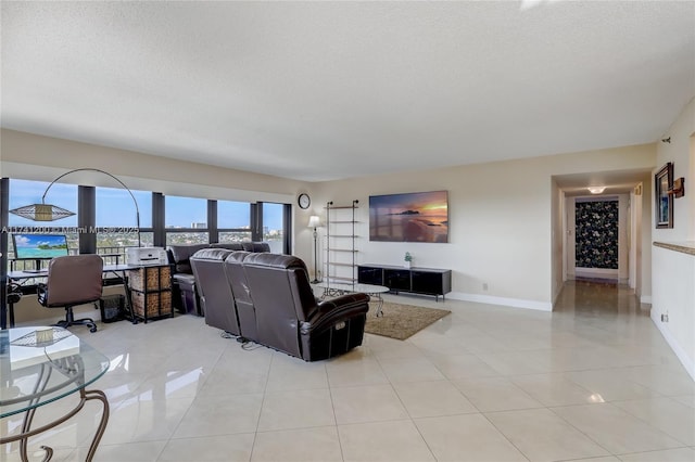 living room featuring light tile patterned floors and a textured ceiling