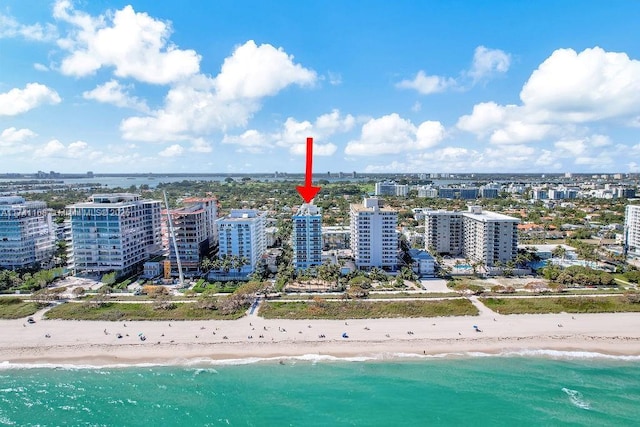 drone / aerial view featuring a water view and a beach view