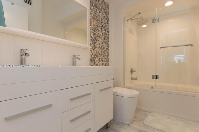 full bathroom with vanity, bath / shower combo with glass door, and toilet