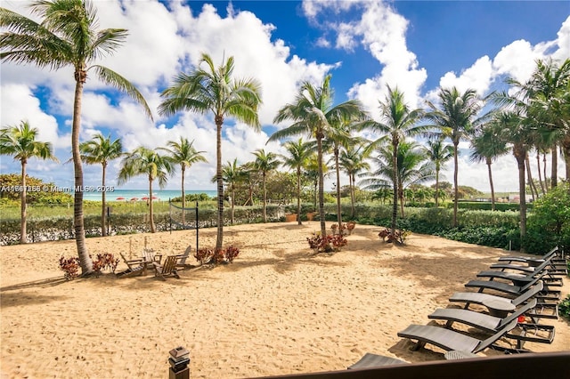 view of home's community featuring a water view and a beach view