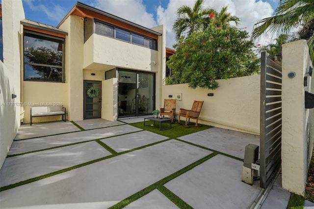 back of property featuring a patio area