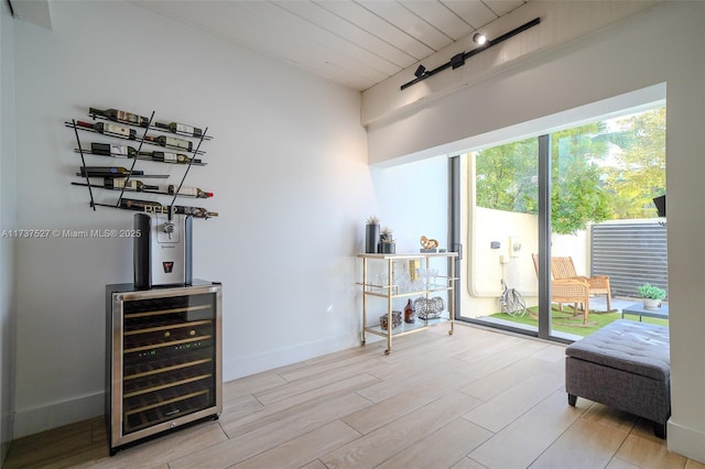 interior space with wine cooler, wood ceiling, and light hardwood / wood-style floors