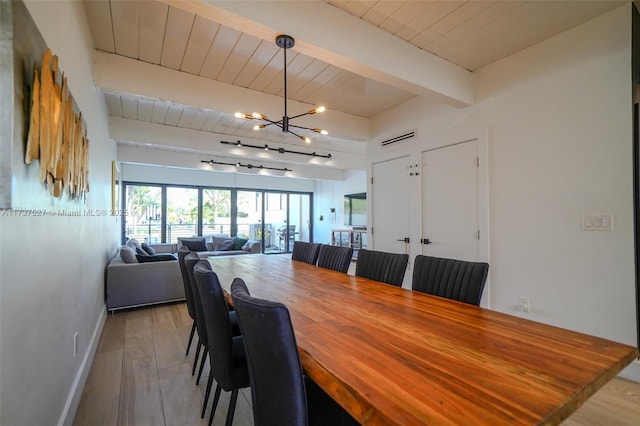 dining room with wood ceiling, beam ceiling, rail lighting, and light wood-type flooring