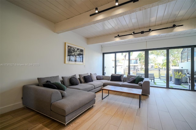 living room featuring wood ceiling, beam ceiling, rail lighting, and light wood-type flooring