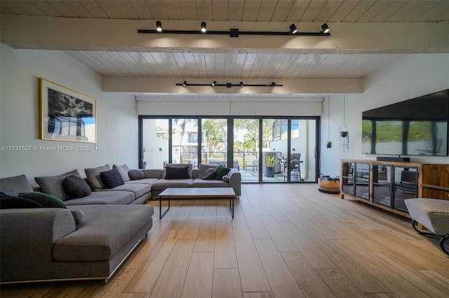 living room featuring rail lighting, wood ceiling, beam ceiling, and light hardwood / wood-style flooring