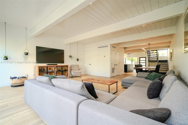 living room with beamed ceiling and hardwood / wood-style floors