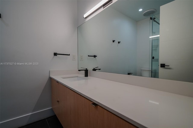 bathroom with tile patterned floors, toilet, and vanity