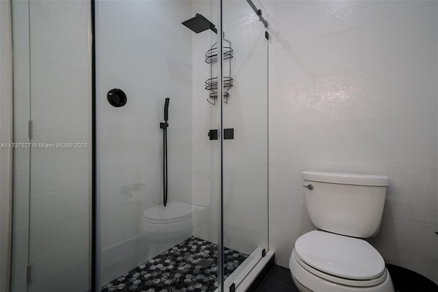 bathroom with an enclosed shower and toilet