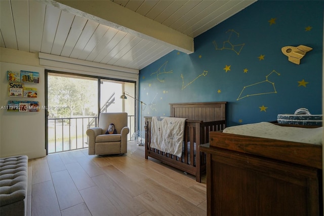 bedroom featuring lofted ceiling with beams, access to exterior, wooden ceiling, and light hardwood / wood-style floors