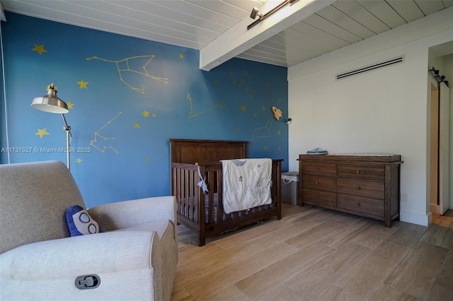 bedroom featuring beamed ceiling, wooden ceiling, and light hardwood / wood-style flooring