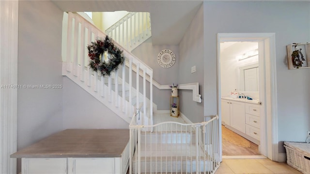 stairway featuring tile patterned flooring