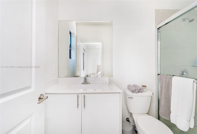 bathroom with vanity, toilet, and walk in shower