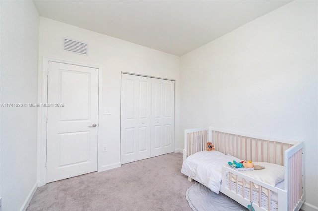 carpeted bedroom with a closet