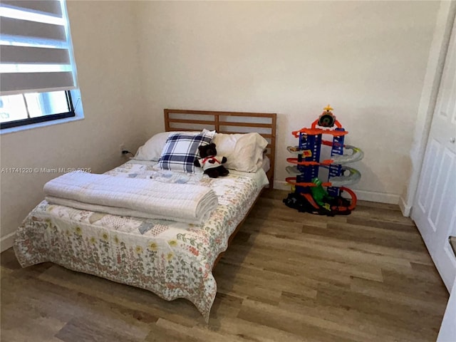 bedroom with wood-type flooring