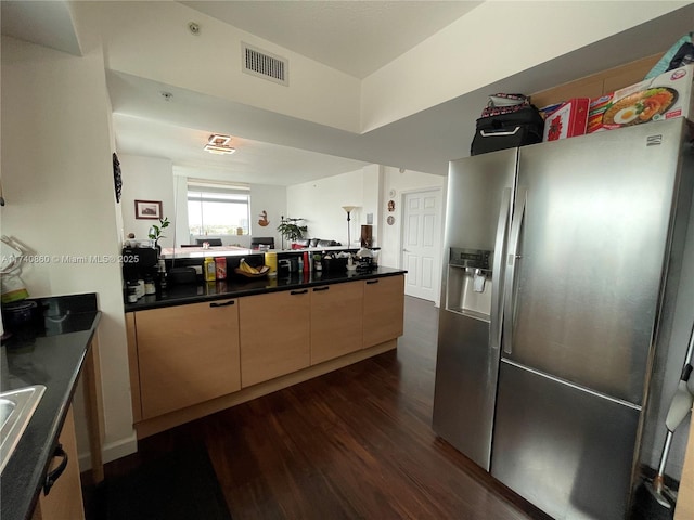 kitchen with dark hardwood / wood-style flooring and stainless steel fridge with ice dispenser