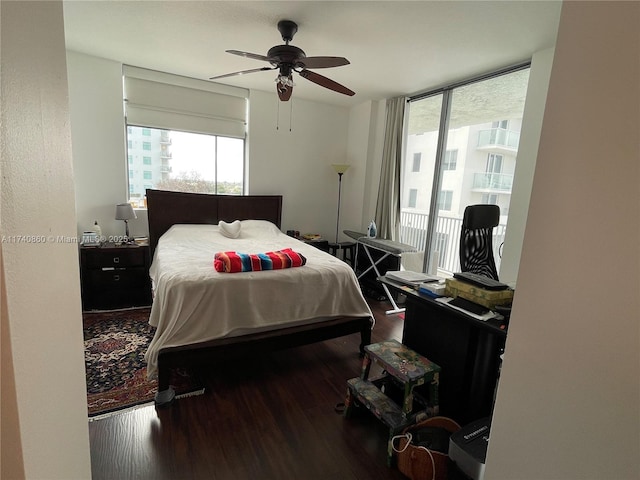 bedroom with hardwood / wood-style flooring, ceiling fan, access to exterior, and multiple windows