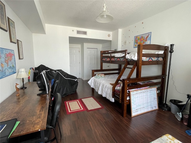 bedroom featuring dark hardwood / wood-style floors and a textured ceiling