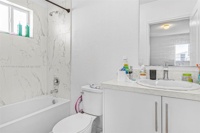 full bath with toilet, a textured wall, vanity, and bathing tub / shower combination