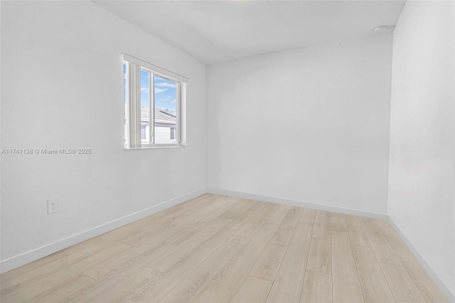 unfurnished room with light wood finished floors and baseboards