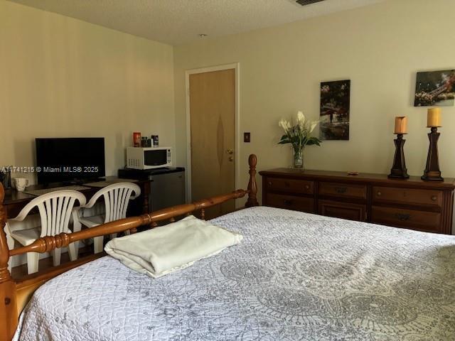 bedroom with refrigerator