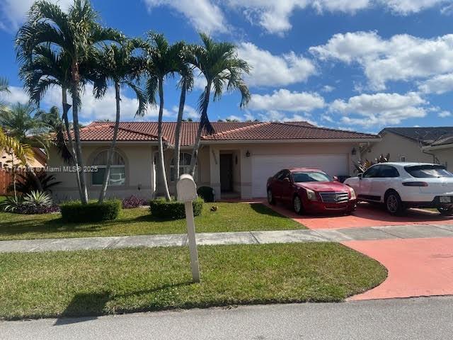 view of front facade featuring a garage and a front lawn