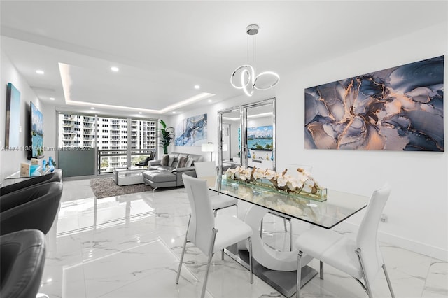 dining area with a notable chandelier, recessed lighting, baseboards, marble finish floor, and a raised ceiling