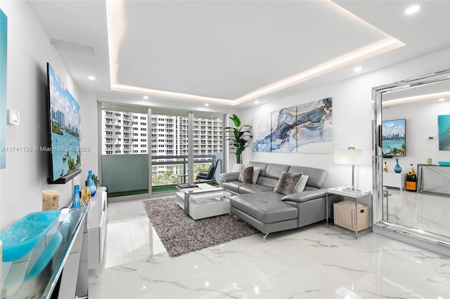 living room with marble finish floor, a raised ceiling, and recessed lighting