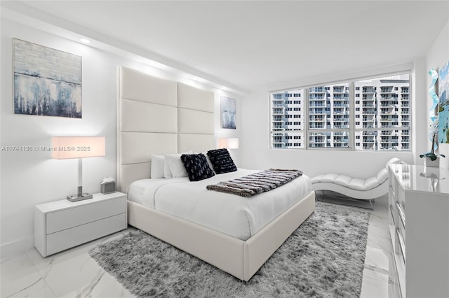 bedroom featuring marble finish floor