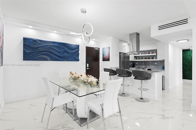 dining space featuring marble finish floor, visible vents, and baseboards