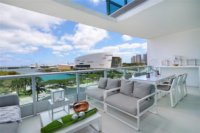 balcony featuring a water view and outdoor lounge area