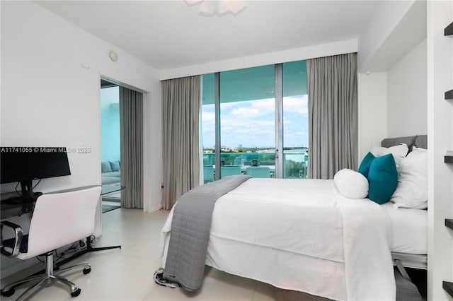 bedroom featuring a water view and access to exterior