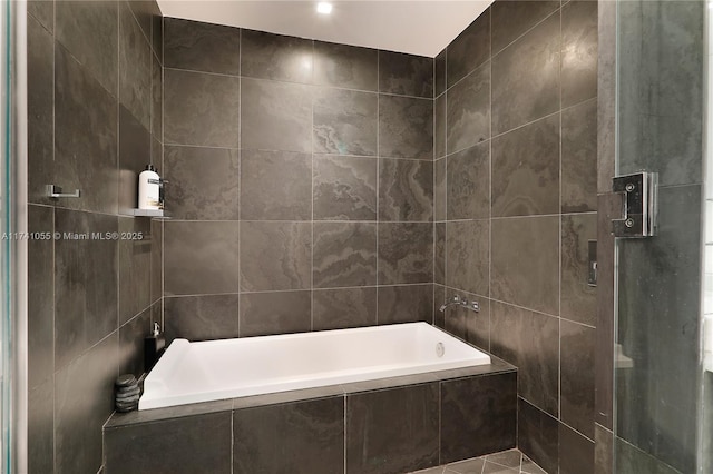 bathroom featuring tile walls and plus walk in shower