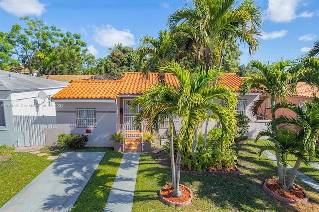 mediterranean / spanish-style home with a front lawn