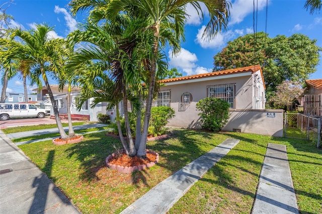 mediterranean / spanish home featuring a front yard