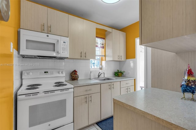 kitchen with tasteful backsplash, sink, white appliances, and light brown cabinets