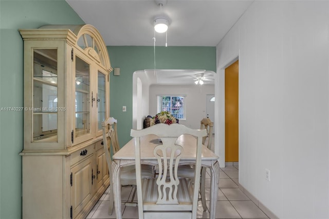 tiled dining room featuring ceiling fan