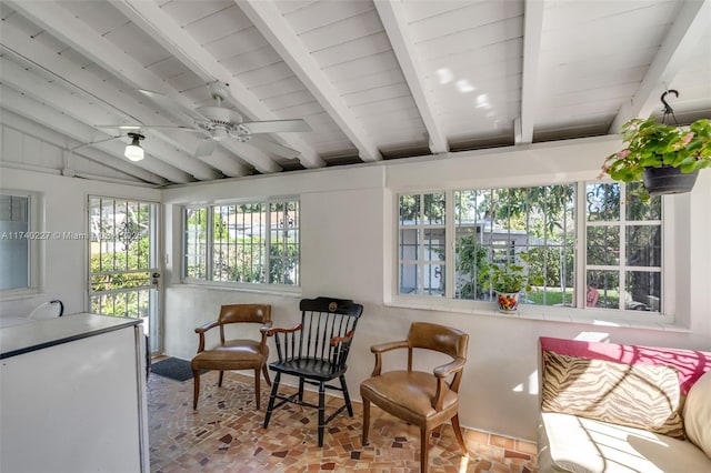 sunroom featuring ceiling fan and lofted ceiling with beams