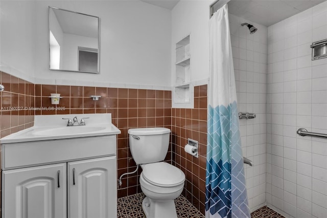 bathroom featuring vanity, toilet, a shower with shower curtain, and tile walls