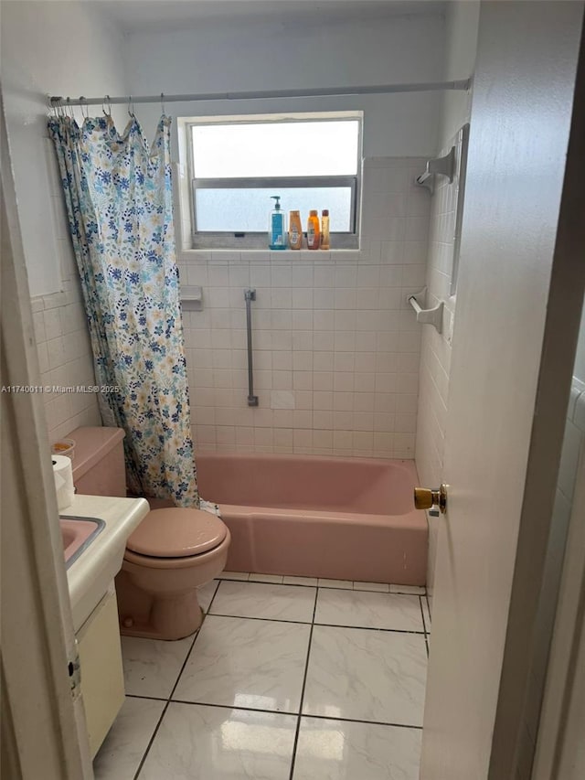 full bathroom with vanity, tile walls, shower / bath combination with curtain, and toilet