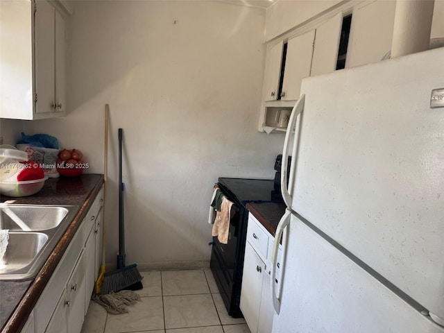 kitchen with black / electric stove, sink, white fridge, and white cabinets