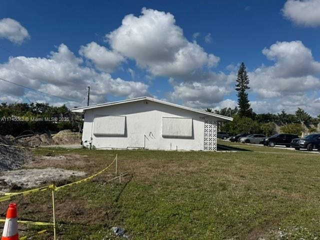 view of property exterior featuring a lawn