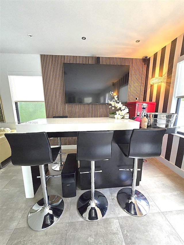 bar with white cabinets and a wealth of natural light