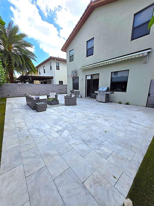 view of patio with an outdoor living space with a fire pit and grilling area