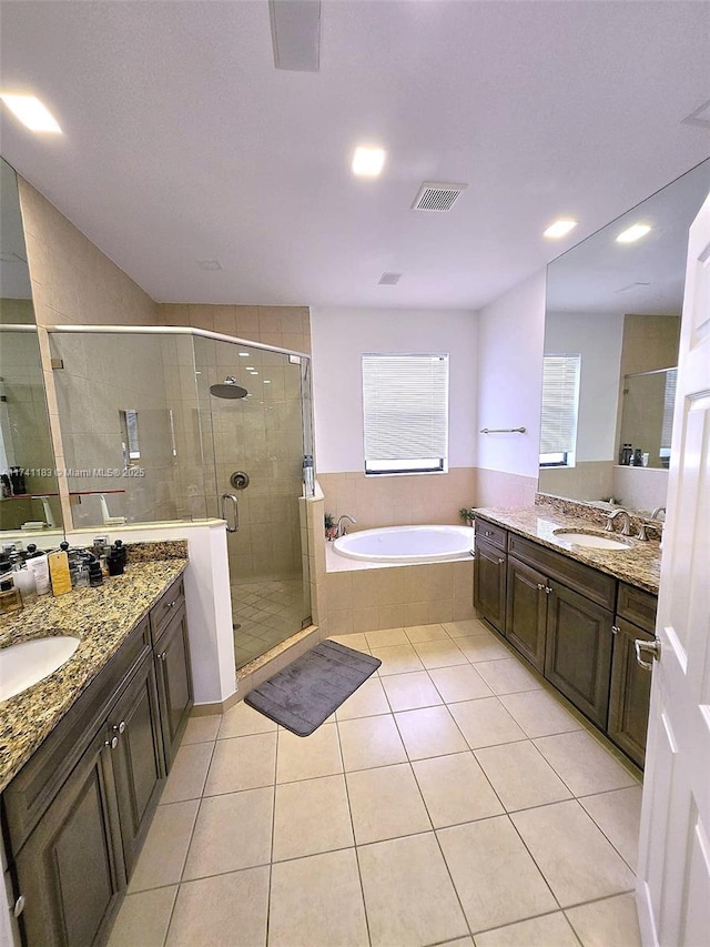 bathroom featuring tile patterned flooring, vanity, and separate shower and tub