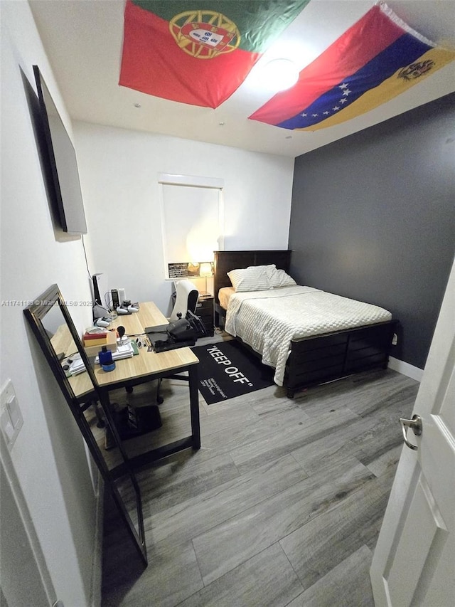 bedroom with hardwood / wood-style floors