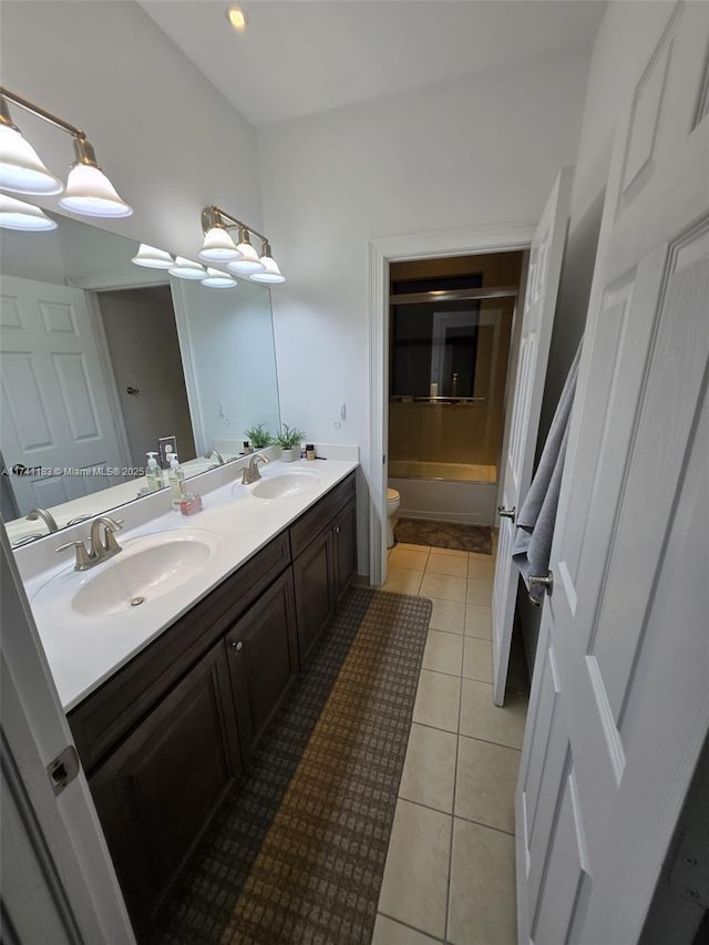 bathroom featuring vanity, tile patterned floors, and toilet