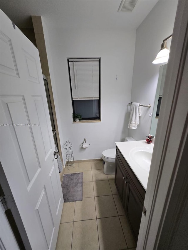 bathroom featuring vanity, toilet, and tile patterned flooring