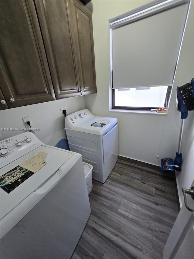 washroom featuring cabinets, washer and dryer, and dark hardwood / wood-style flooring