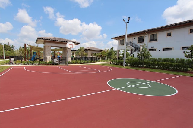 view of sport court featuring a playground